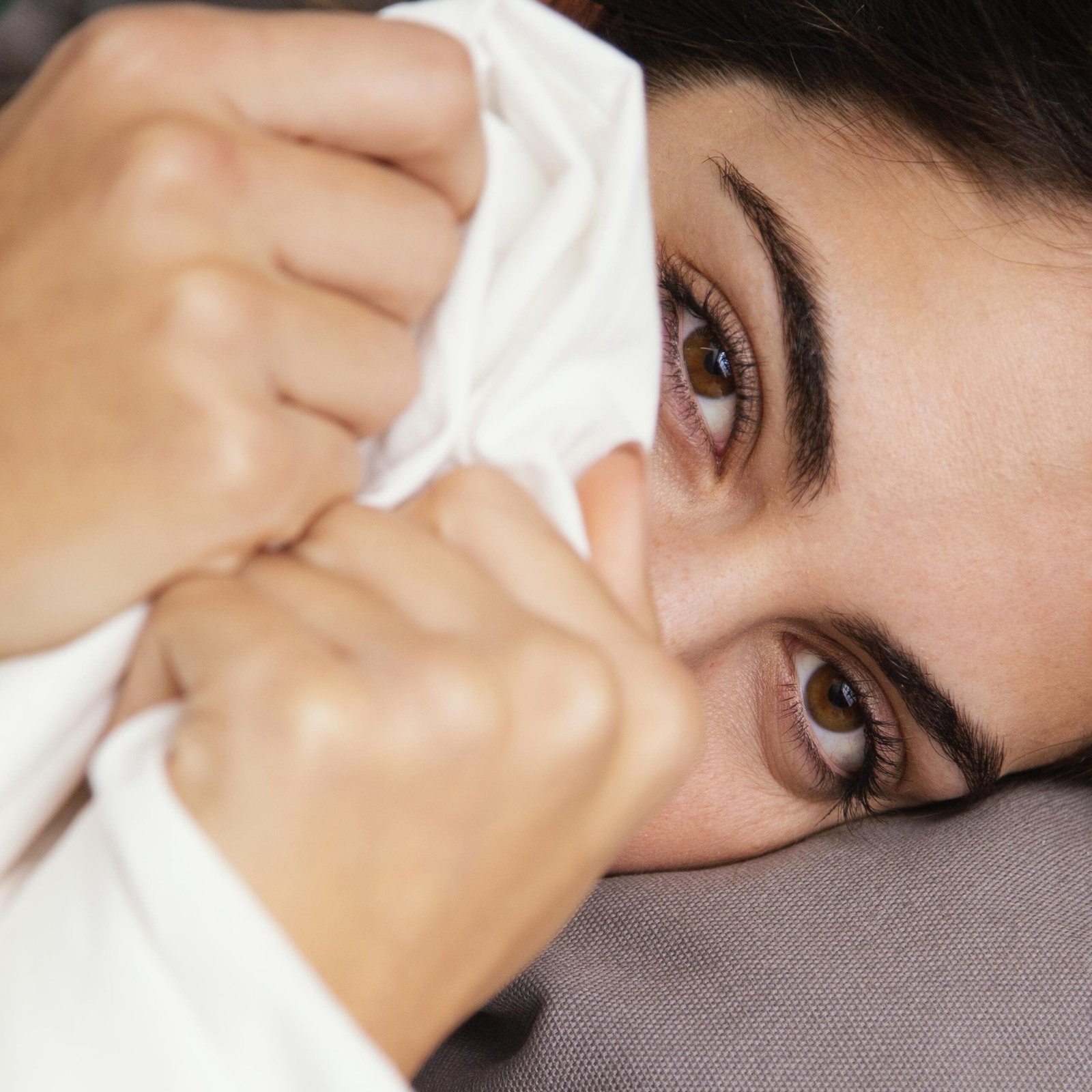 woman-hiding-sheets-home